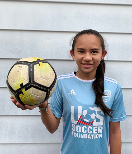 image of child holding soccer ball